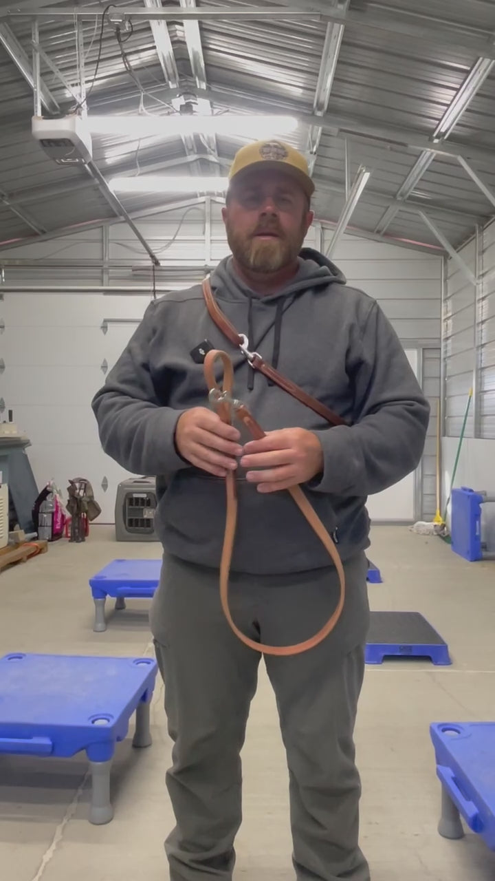Jared from Best Gun Dogs presents a four-foot handcrafted leather leash made from high-quality Herman oak leather, featuring a stainless steel swivel snap, copper rivets, and expertly burnished edges for comfort. The video showcases both a brand-new leash and a well-maintained, frequently used one demonstrated by Jared.